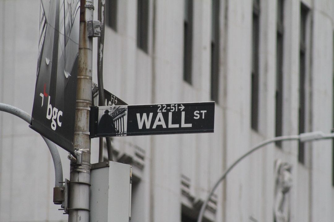 A black-and-white Wall Street sign