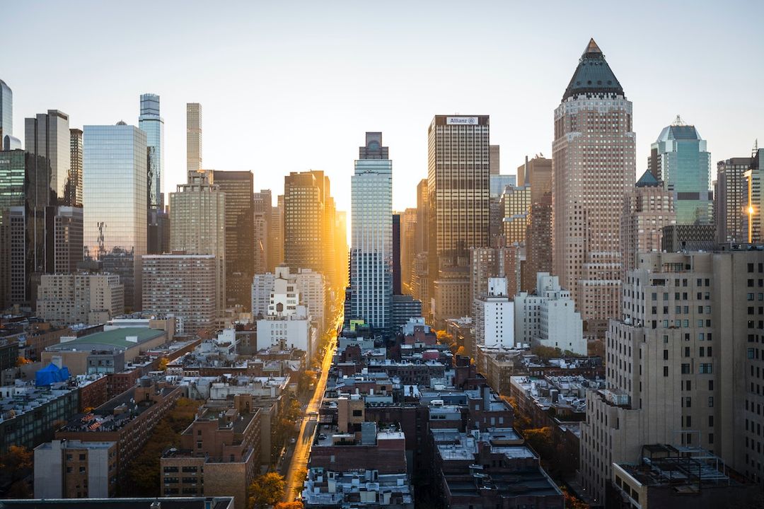 A dense city skyline at sunset